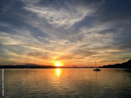 Sundown over a beautiful bay with a sailboat anchored out in the Gulf Islands, British Columbia, Canada