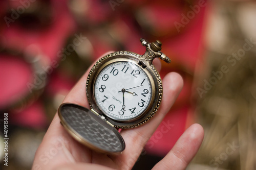 Vintage styled pocket watch in hand.