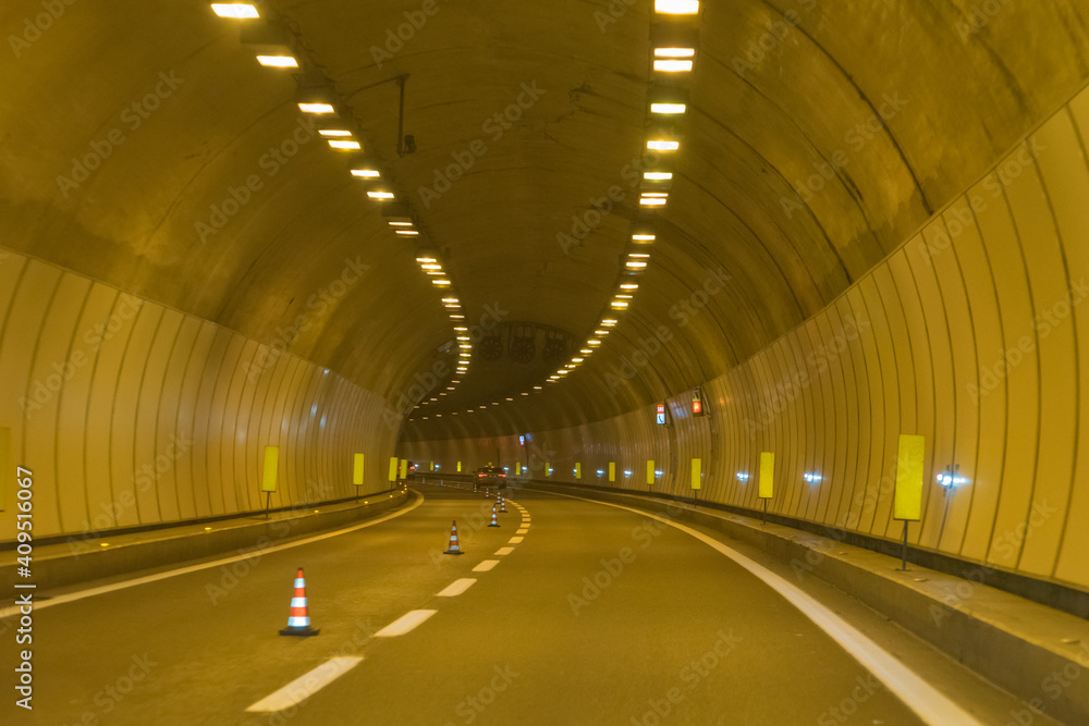 Drive through an empty highway tunnel before exciting the light Drive through an empty highway tunnel before exciting the light