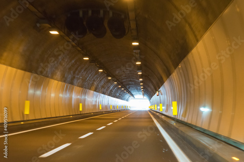 Drive through an empty highway tunnel before exciting the light © tina7si