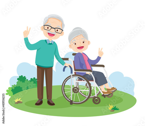 happy edlerly victory hand sitting on wheelchair in the park