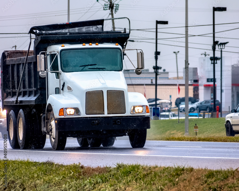 Dump Truck Leading Traffic On A Wet Winter Day Dump Truck Leading Traffic On A Wet Winter Day