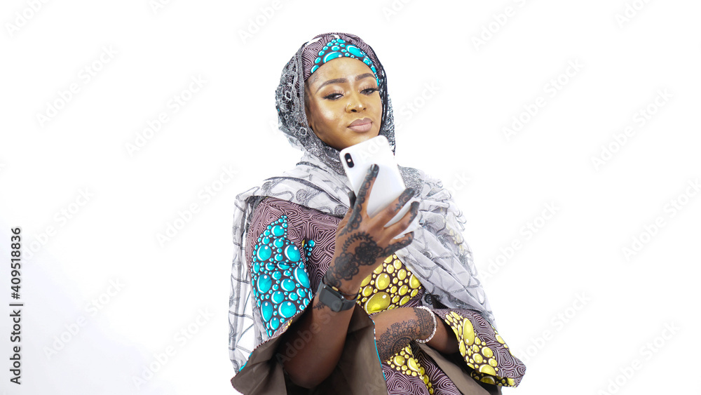 Fototapeta premium Portrait of pretty African Fulani woman using a mobile phone 