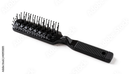 New black hair brush with handle isolated on white background. Combing and hair care  hairdressing tools  haberdashery. Studio shot.