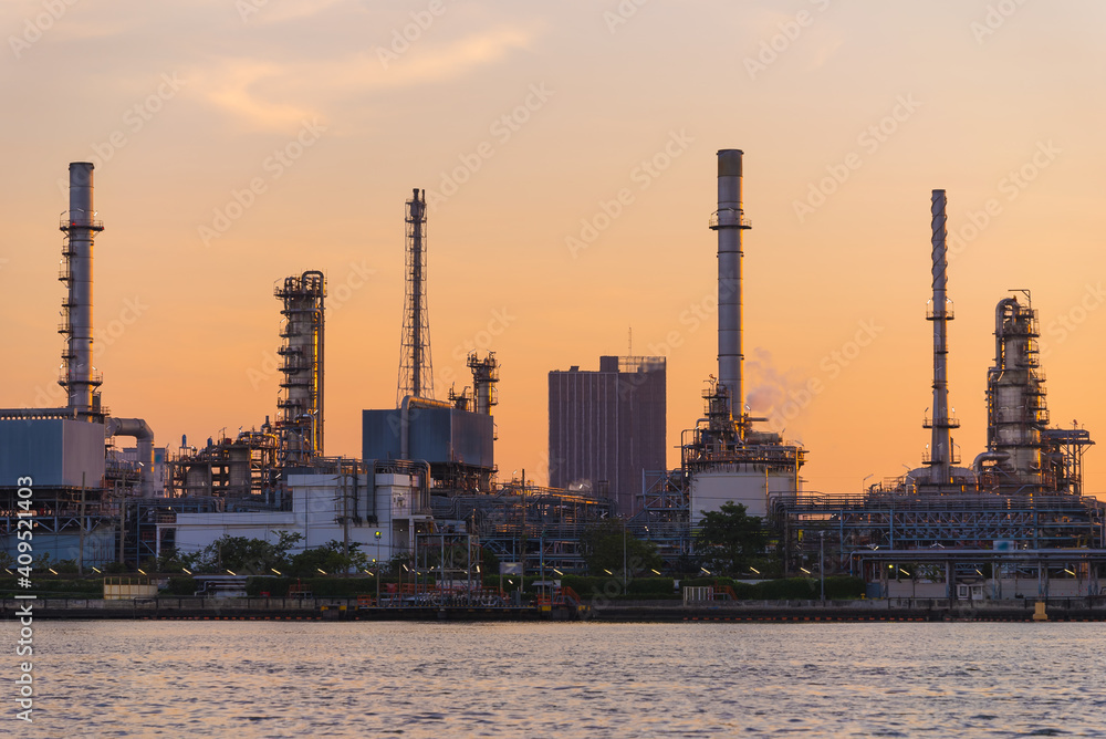 Fototapeta premium Close up oil and gas industrial, Refinery factory oil storage tank and pipeline steel at sunrise