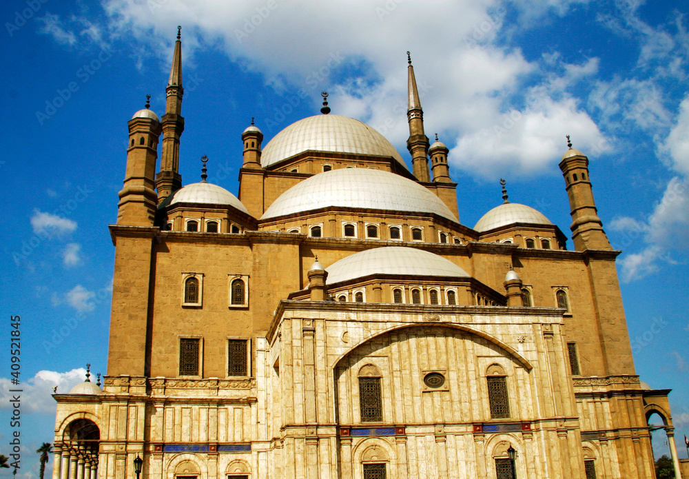 Façade of yellow Mosque with beautiful sky in the background