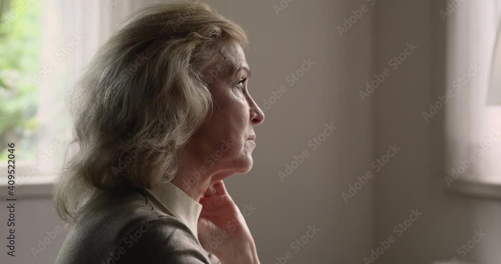 Head shot side view thoughtful older senior retired woman looking in distance, feeling melancholic alone indoors. Unhappy pensive middle aged lady thinking of personal problems, retirement lifestyle. Head shot side view thoughtful older senior retired woman looking in distance, feeling melancholic alone indoors. Unhappy pensive middle aged lady thinking of personal problems, retirement lifestyle.