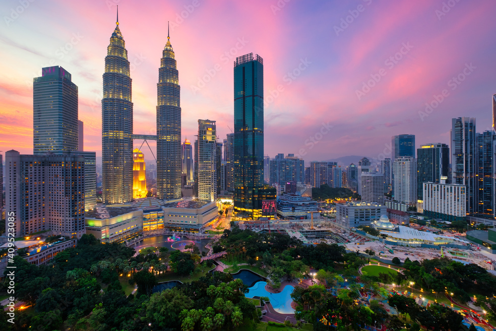Kuala Lumpur skyline financial downtown district and KLCC park view at sunset