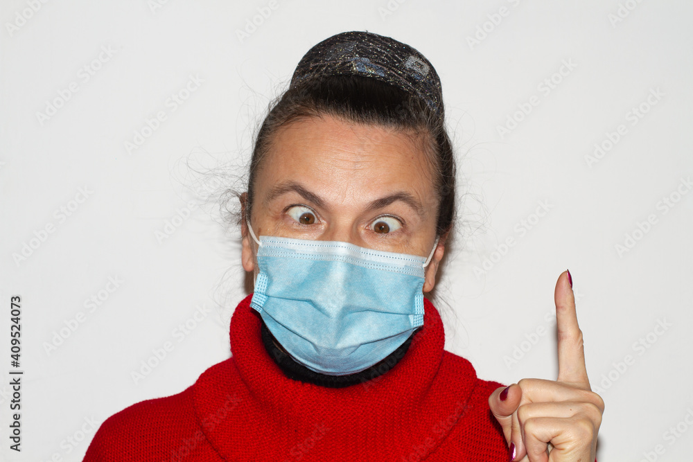 Woman in medical mask isolated on white finger up slanted eyes softfocus Woman in medical mask isolated on white finger up slanted eyes softfocus