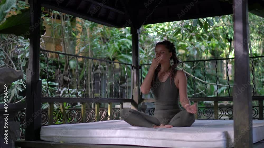 Slim female yogi getting energy inspiration and zen from nature environment spending leisure for calmness feeling, Caucasian girl in tracksuit enjoying morning meditation Slim female yogi getting energy inspiration and zen from nature environment spending leisure for calmness feeling, Caucasian girl in tracksuit enjoying morning meditation