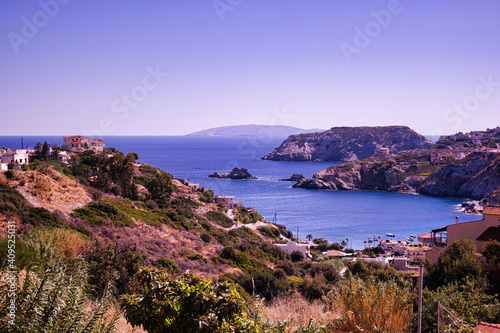 Crete, Greece: A wide angle seascape near stalida beach of blue mediterranean sea against rocky mountain. Crete seascape against dramatic clouds