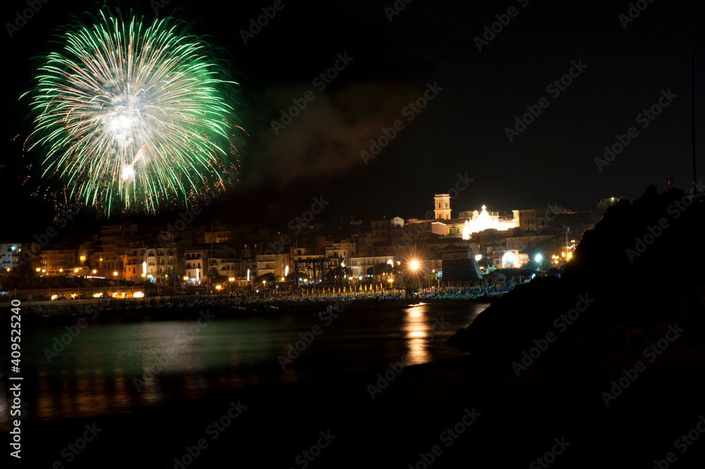 Pyrotechnics display over the waterfront on the quayside of the village of Marina di Camerota, Salerno, Italy.