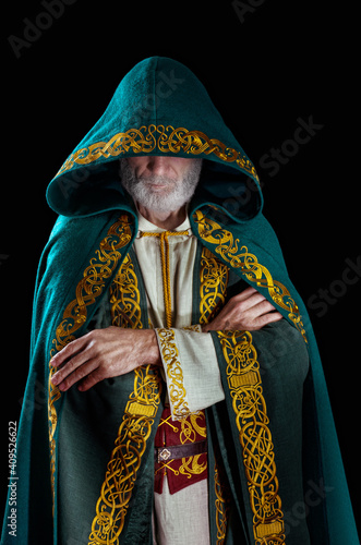 The wise old wizard wearing a hooded cloak.