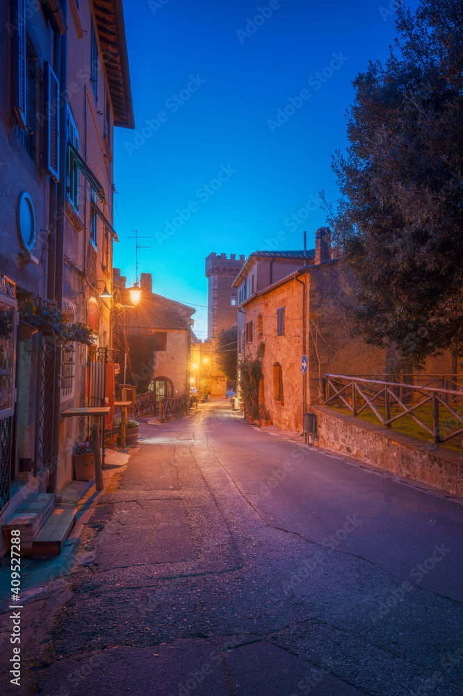 Bolgheri medieval village street at sunset. Castagneto Carducci, Tuscany, Italy