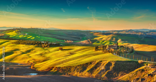 Tuscany landscape at sunset, rolling hills, trees and green fields. Italy