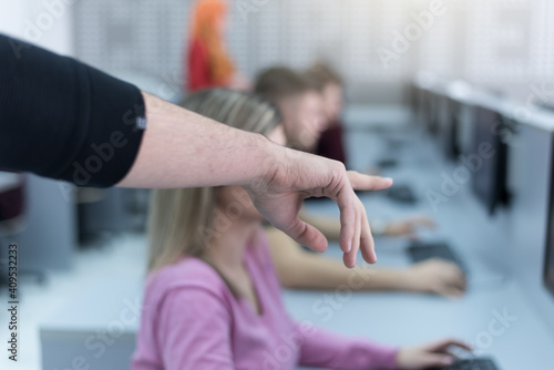 Teacher assisting college student in a computer lab. Technology and education, programming concept