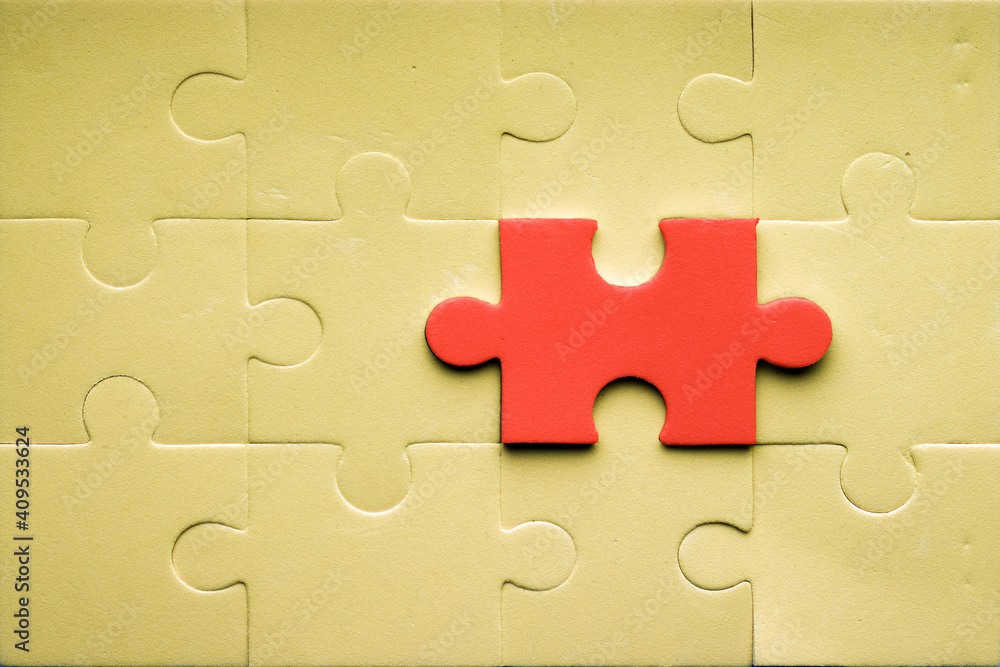 Fototapeta premium A different puzzle piece is connected to other puzzles