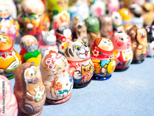 Tiny Matryoshka nesting dolls lined up on table