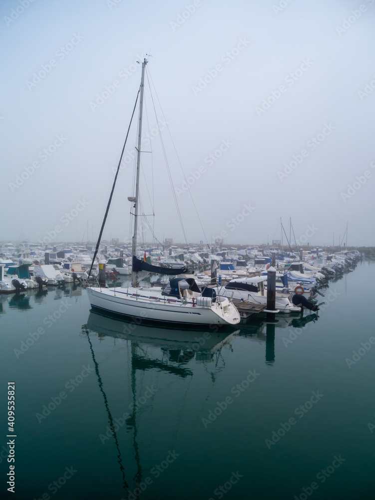 Boats in the fog in the bay of Cadiz capital, Andalusia. Spain. Europe.
