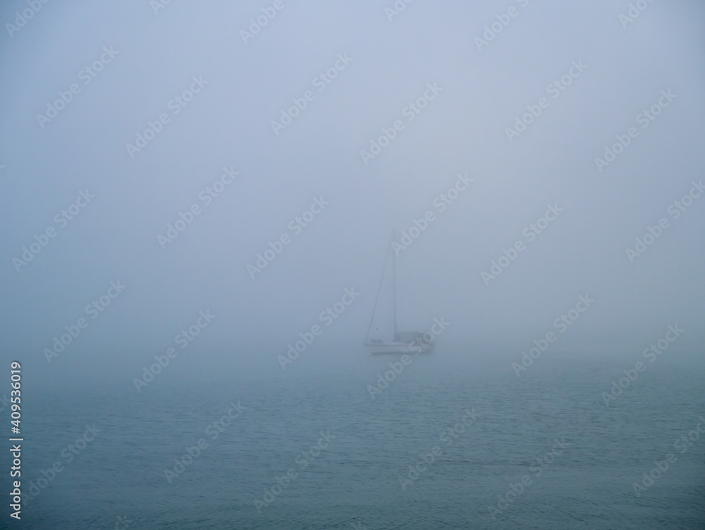 Boat in the fog in the bay of Cadiz capital, Andalusia. Spain. Europe.
