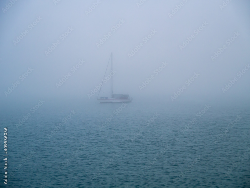 Boat in the fog in the bay of Cadiz capital, Andalusia. Spain. Europe.
