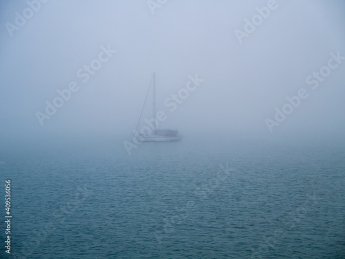 Boat in the fog in the bay of Cadiz capital, Andalusia. Spain. Europe. 