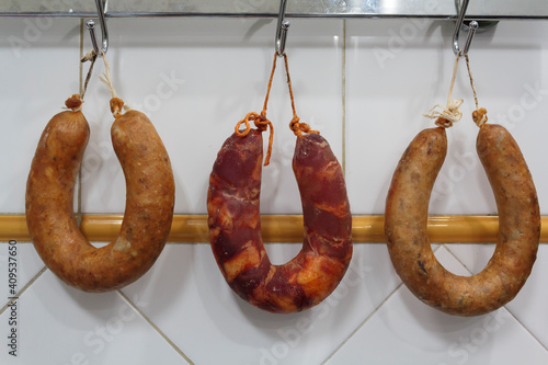 Fototapeta Naklejka Na Ścianę i Meble -  Portuguese smoked sausages, alheira and chorizo hanging for dry