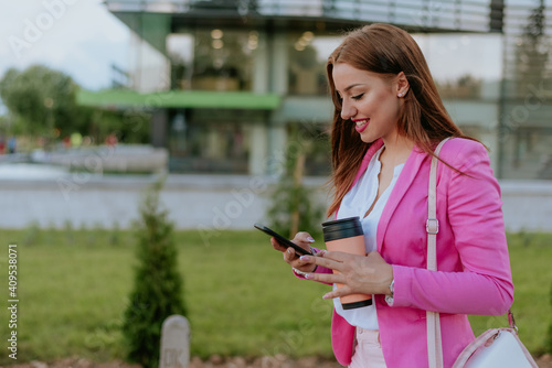 Beautiful woman using mobile phone on the street