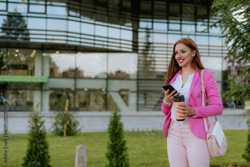 Beautiful woman using mobile phone on the street