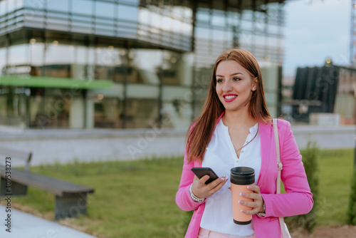 Beautiful woman using mobile phone on the street
