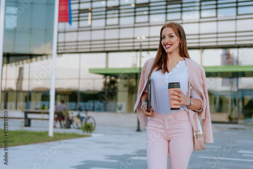 Woman with file folder in hands and coffe cup