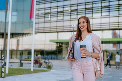 Woman with file folder in hands and coffe cup