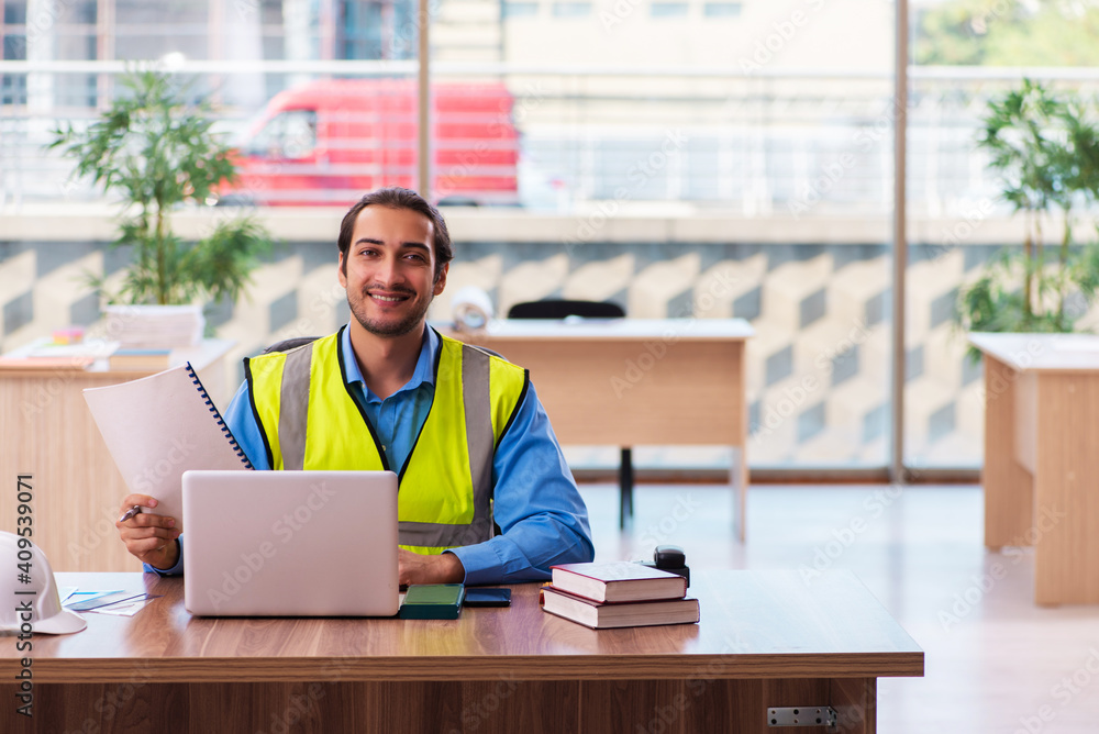 Young male architect working in the office Young male architect working in the office