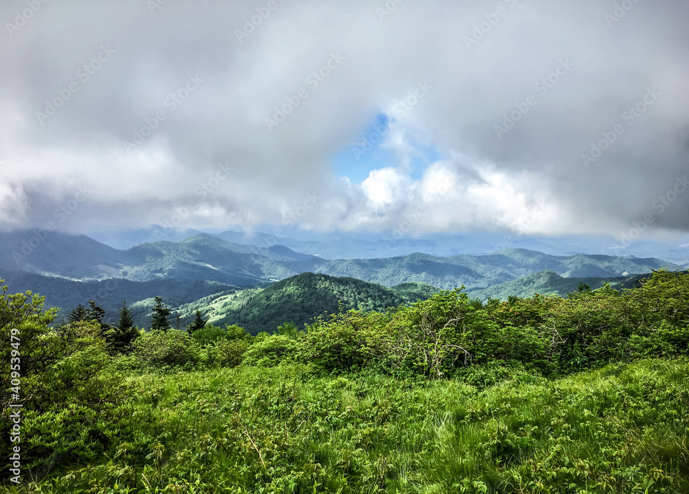 Clouds and broken blue sky over the Balds in Roan Mountain. Tennessee, North Carolina.