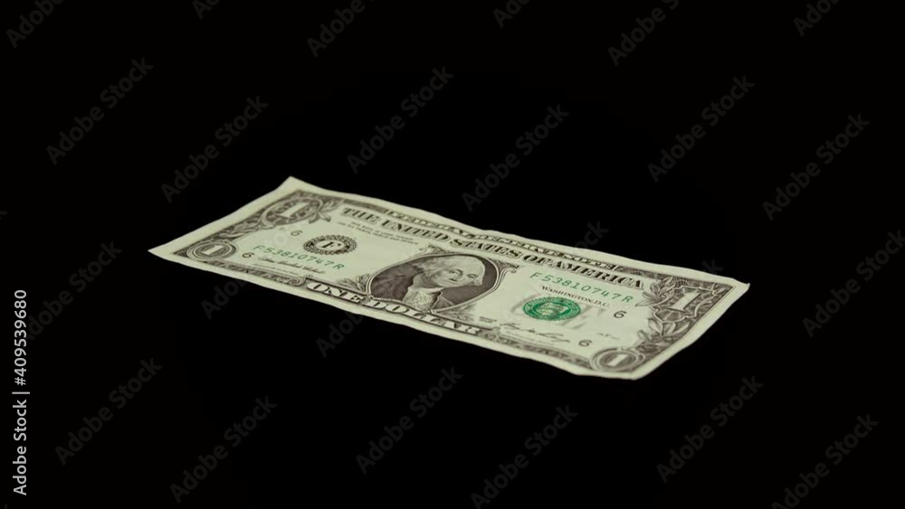 One US dollar rotating on a black background. Concept: money, single bill, banknote, banking, finances One US dollar rotating on a black background. Concept: money, single bill, banknote, banking, finances