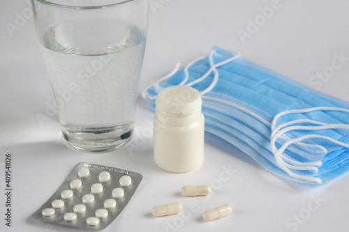 Medical tablets, glass of water and masks