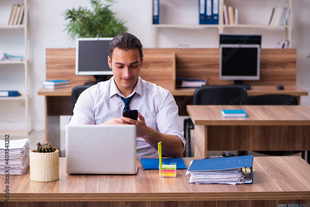 Young male employee working in the office Young male employee working in the office