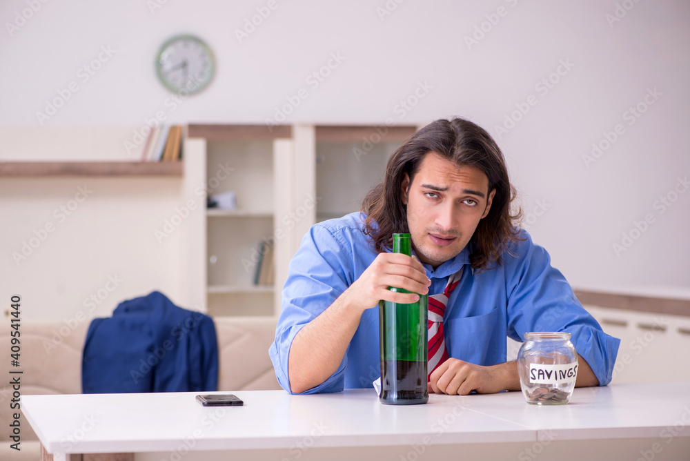 Young male employee being fired from his work at home Young male employee being fired from his work at home
