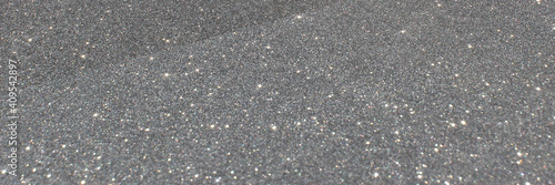 White and grey glitter bokeh circle glow blurred and blur abstract. Glittering shimmer bright luxury. White and silver glisten twinkle for texture wallpaper and background backdrop.
