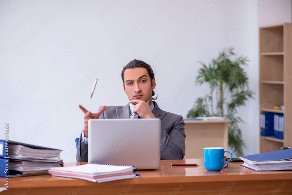 Young male employee working in the office Young male employee working in the office
