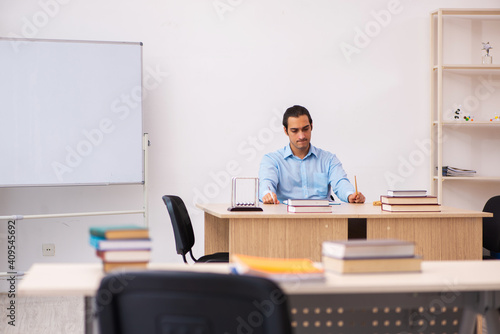 Young male teacher in the classroom © Elnur
