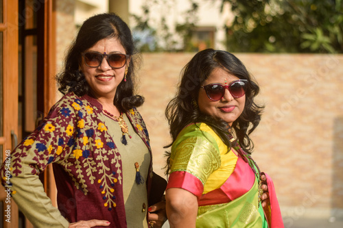 Bareilly, India 2020: Indian ladies posing for photo. They are wearing traditional Indian dress with Sun glasses photo