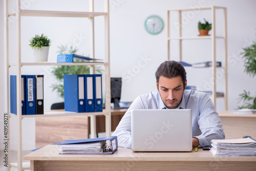 Young male bookkeeper working in the office