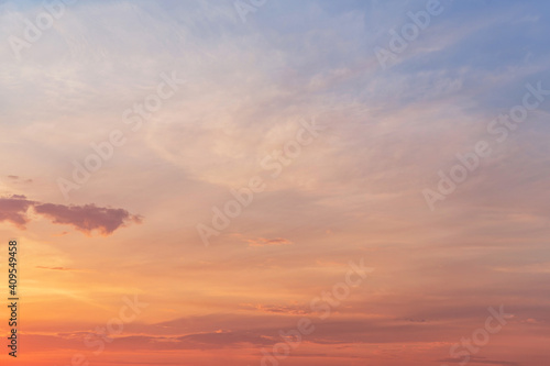 Sunrise, sunset blue orange pink gentle sky in sunlight with cirrus clouds abstract background texture