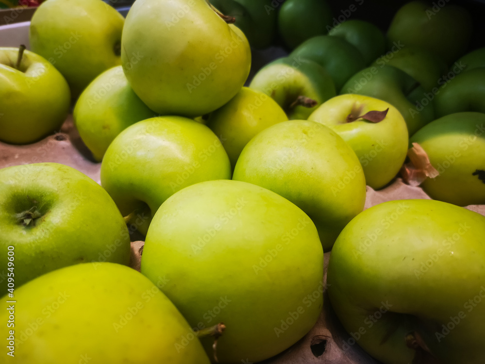 selling green apples in a box by weight in a supermarket selling green apples in a box by weight in a supermarket