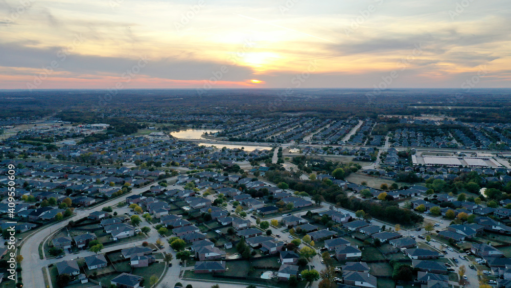 look at a neighborhood from the sky during a sunset