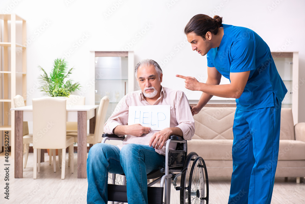 Old man in wheel-chair and young bad caregiver indoors