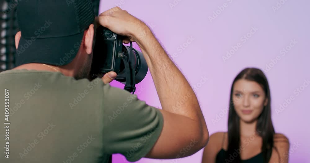 Attractive fashion model of caucasian ethnicity posing for a photographer, who taking photos with professional camera. Attractive fashion model of caucasian ethnicity posing for a photographer, who taking photos with professional camera.