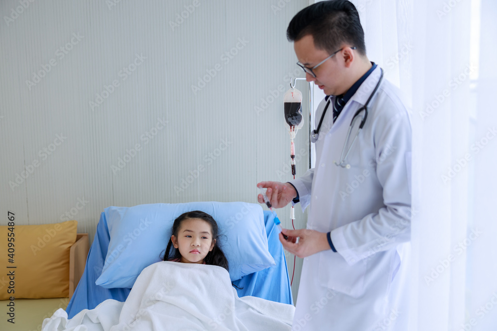 asian doctor doing syringe to check for blood. Analyze healthy of girl lying in bed asian doctor doing syringe to check for blood. Analyze healthy of girl lying in bed