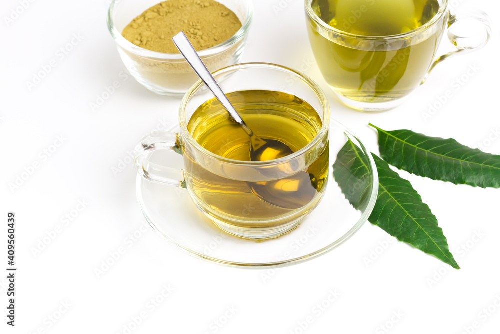 Neem tea in transparent glass cup and fresh neem leaf with powder isolated on white background. Neem tea in transparent glass cup and fresh neem leaf with powder isolated on white background.